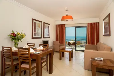 a table with food and drinks on a balcony with the ocean at Cerro Mar Atlantico & Cerro Mar Garden in Albufeira