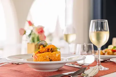 a white plate of food on a table at Grand Muthu Oura View Beach Club in Albufeira