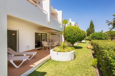 a patio of a house with a chair and a table at Victory Village 2A in Quinta do Lago