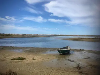 a boat sitting on the shore of a body of water at Victory Village 2A in Quinta do Lago