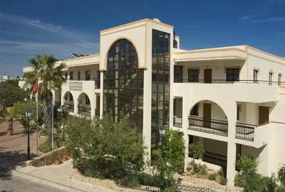 a white building with a large window at Alfagar Cerro Malpique in Albufeira