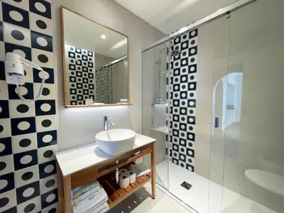 a bathroom with a sink and a glass shower at Alfagar Cerro Malpique in Albufeira