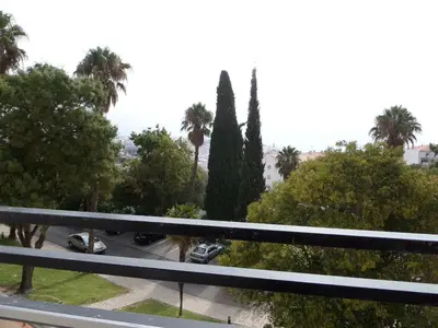 a view of a parking lot with palm trees and cars at Albufeira Jardim by Umbral in Albufeira