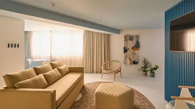a balcony with two chairs and a view of a city at Hotel Indigo Albufeira by IHG in Albufeira