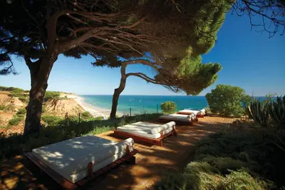 a hotel room with a bed and a balcony at PortoBay Falesia in Albufeira
