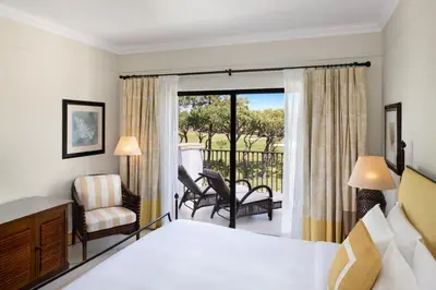 a hotel room with a bed and a balcony at Pine Cliffs Residence, a Luxury Collection Resort, Algarve in Albufeira