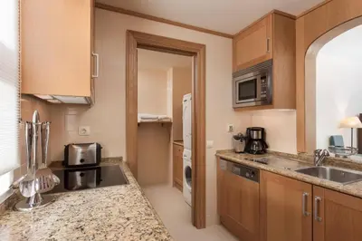 a kitchen with a sink and a microwave at Pine Cliffs Residence, a Luxury Collection Resort, Algarve in Albufeira