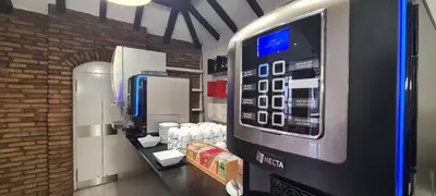 a drink dispenser in a store with a vending machine at Albufeira Beach Hotel by Kavia in Albufeira