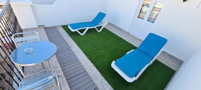 a balcony with a blue chair and a table at Albufeira Beach Hotel by Kavia in Albufeira