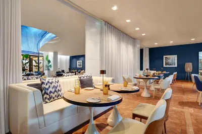 a restaurant with tables and chairs and a large ceiling at Hilton Vilamoura in Vilamoura