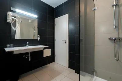 a bathroom with a sink and a shower at KR Hotels - Albufeira Lounge in Albufeira