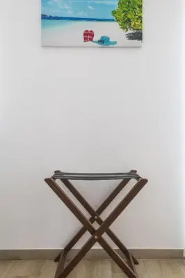 a glass table against a white wall with a picture at Casa Mar d'Alma - 100m from the Beach in Albufeira