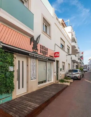 a building with a sign for a sushi restaurant at Casa Mar d'Alma - 100m from the Beach in Albufeira