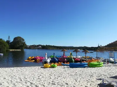 a group of boats on a beach near the water at Victory Village Club 9F in Quinta do Lago