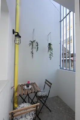 a room with two chairs and a table and a window at Dubocage45Citycenter in Faro