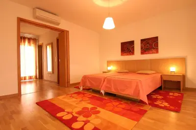 a bedroom with a bed and a rug on the floor at Orada Apartamentos Turísticos - Marina de Albufeira in Albufeira