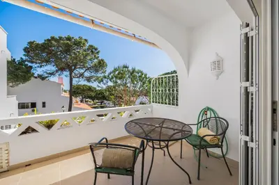 a white bedroom with a large bed and a balcony at Vale Do Lobo Resort in Vale do Lobo