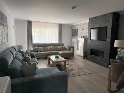 a living room with a couch and a tv at Vila Sol, Apartment 468 in Quarteira