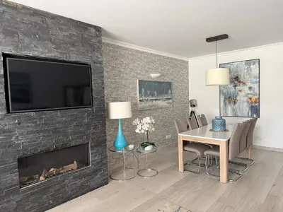 a living room with a fireplace with a tv above it at Vila Sol, Apartment 468 in Quarteira