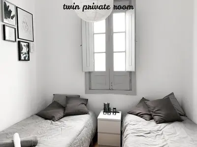 a bedroom with two beds and a window at Atelier 3 - Boutique Rooms in Loulé