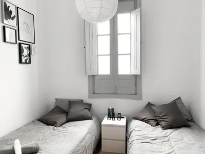 two beds in a white room with a window and a bedskirts at Atelier 3 - Boutique Rooms in Loulé
