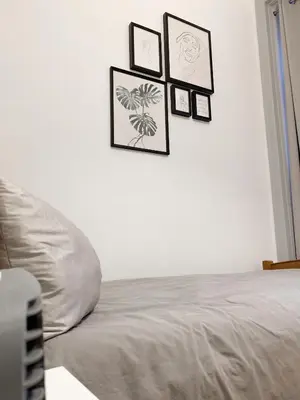 a bedroom with a bed with four pictures on the wall at Atelier 3 - Boutique Rooms in Loulé