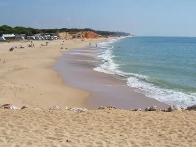 a beach with people on it and the ocean at Varandas de Carteia G/F in Quarteira