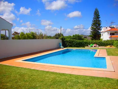 a swimming pool in the yard of a house at Balaia Harmonia in Albufeira