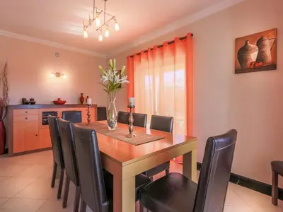 a dining room with a wooden table and chairs at Luxury Holiday Villa Alegria Galé Beach, Albufeira in Albufeira