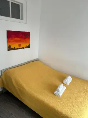 a bedroom with a bed with two towels on it at Casinha in Faro