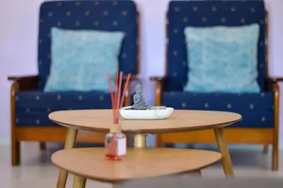 a kitchen with wooden cabinets and a table in it at Apartamento Stª Eulália Deluxe by Umbral in Albufeira