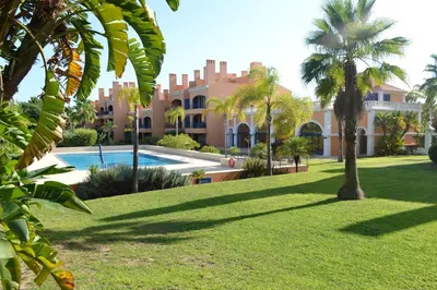 a view of a resort with a swimming pool and palm trees at Golf F5 by Garvetur in Vilamoura