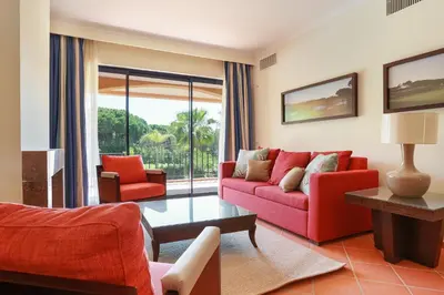 a living room with a red couch and chairs at Golf F5 by Garvetur in Vilamoura