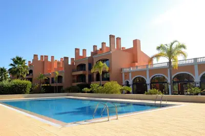 a resort with a swimming pool in front of a building at Golf F5 by Garvetur in Vilamoura