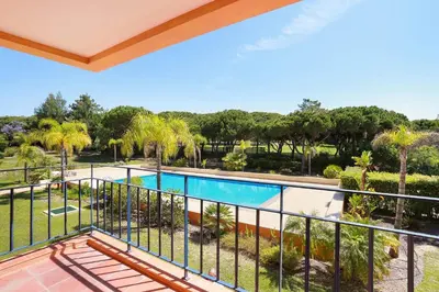a view from the balcony of a house with a swimming pool at Golf F5 by Garvetur in Vilamoura