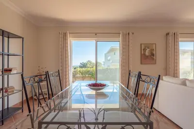 a glass table in a living room with a window at Villa Costa by Gabi Miguel in Albufeira