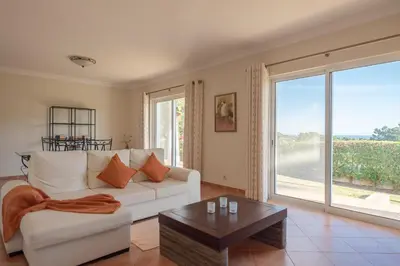 a living room with a white couch and a coffee table at Villa Costa by Gabi Miguel in Albufeira