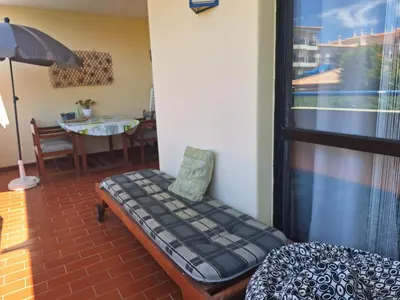 a living room with two beds and a painting of a pier at Apartament Olhos do Mar T1 beach Olhos de Água in Albufeira