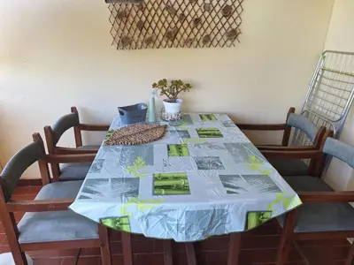 a dining room with a table and chairs and a balcony at Apartament Olhos do Mar T1 beach Olhos de Água in Albufeira