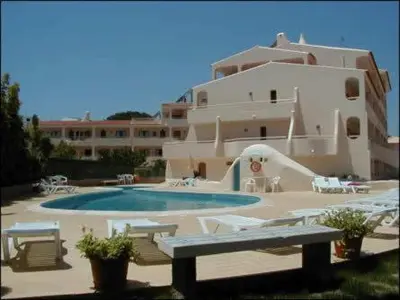 a large building with a swimming pool and a house at Apartament Olhos do Mar T1 beach Olhos de Água in Albufeira
