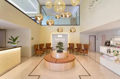 a waiting room at a spa with a table and chairs at Pine Cliffs Village in Albufeira