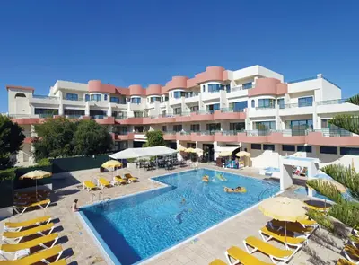 a hotel with a sign on top of it at Grand Muthu Forte Da Oura in Albufeira