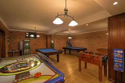 a living room with a pool table in it at Aparthotel Paladim & Alagoamar in Albufeira