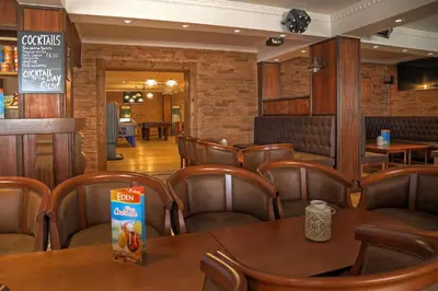 a restaurant with a long table and leather chairs at Aparthotel Paladim & Alagoamar in Albufeira