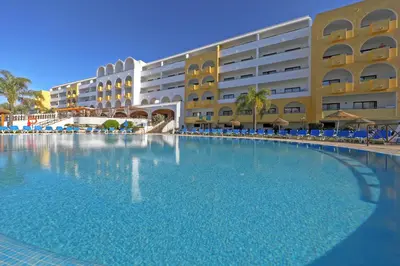 an overhead view of a large swimming pool with people in it at Aparthotel Paladim & Alagoamar in Albufeira