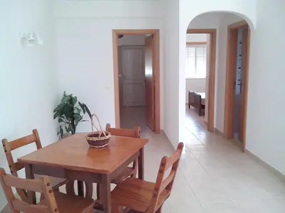 a dining room with a wooden table and chairs at Charming Apartment in Albufeira, 60 m², Mountain View in Albufeira