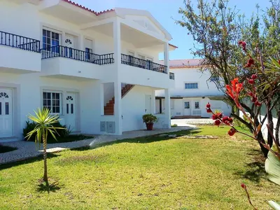 a large white house with a yard at Charming Apartment in Albufeira, 60 m², Mountain View in Albufeira