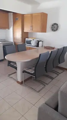 a kitchen with a table and chairs in a room at Apartamento Solar dos Pinheiros in Vilamoura