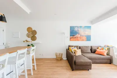 a living room with a couch and a table at Vista Mar in Quarteira
