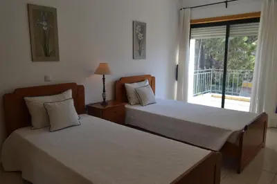 two beds in a room with a window at Eden Vilage by Garvetur in Vilamoura